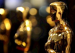 The image shows several golden statuettes in the shape of a human figure. These are commonly known as Oscars, awarded in the film industry worldwide.